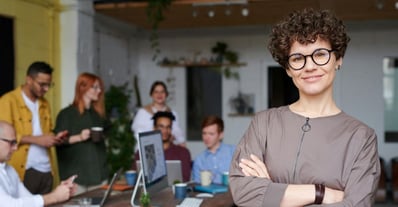 working woman with her team behind her